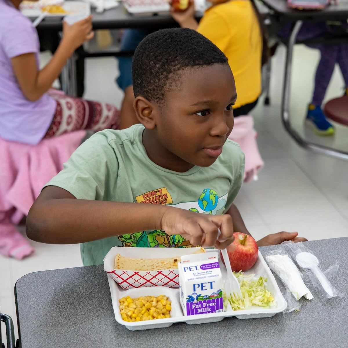  A student enjoys his lunch in the cafeteria